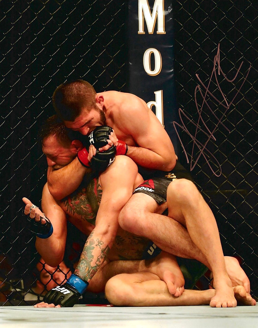 KHABIB NURMAGOMEDOV SIGNED UFC 14x11 KHABIB MCGREGOR PHOTOGRAPH (AFTAL COA)