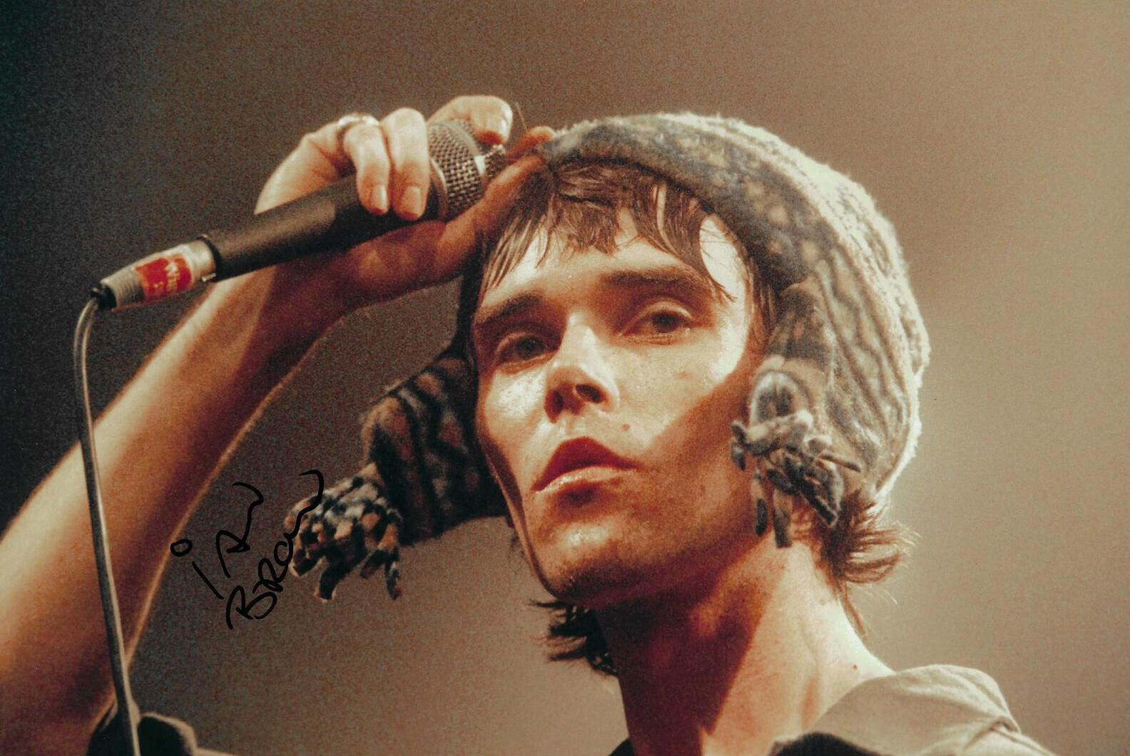 IAN BROWN SIGNED 12X8 STONE ROSES PHOTOGRAPH (AFTAL COA)